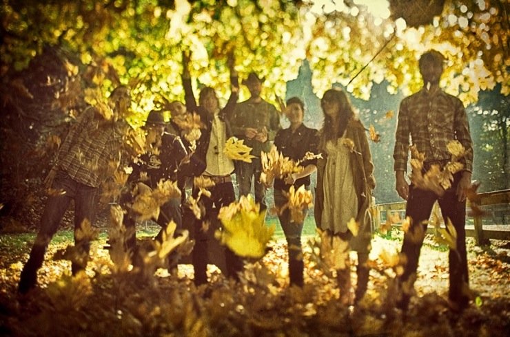 Lonesome Rhodes and the Good Company band members outside throwing leaves.