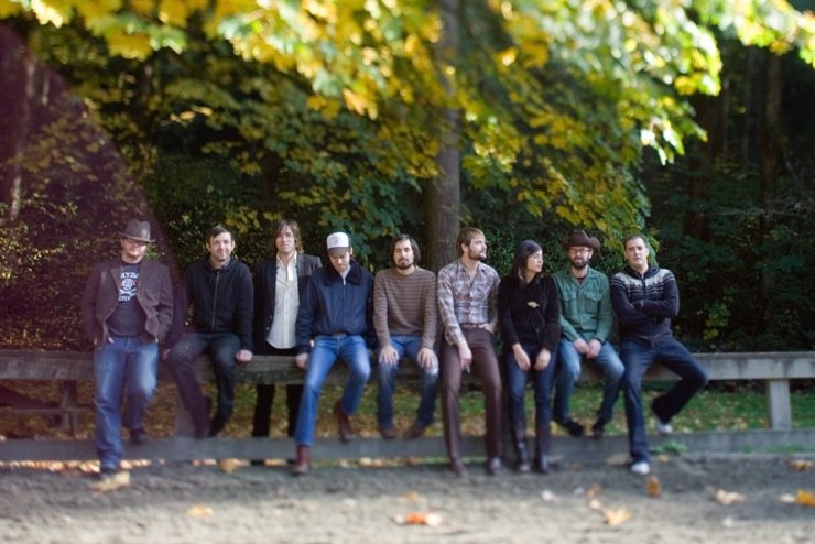 Lonesome Rhodes and the Good Company band members sitting outside.